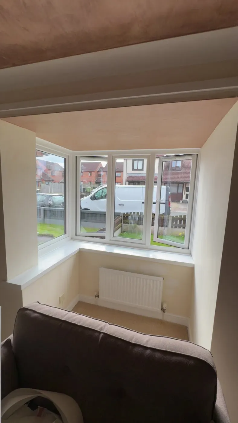 Freshly plastered ceiling above a bay window