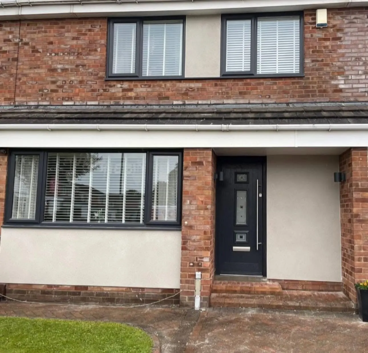 Rendered panels on the front of a brick house